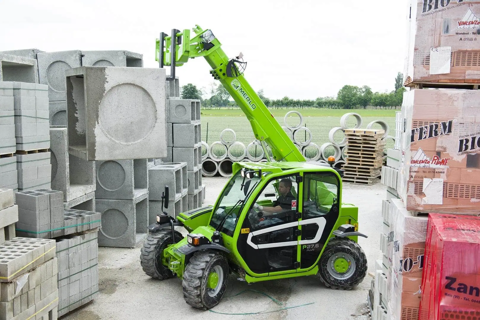 Merlo Panoramic 27.6 starre verreiker met palletvorken bij bouwmateriaalopslag